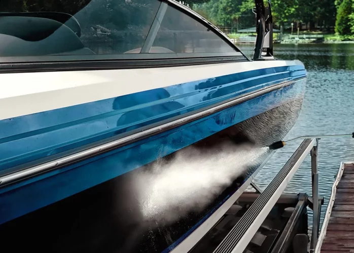 Pressure washer stream on the side of a boat